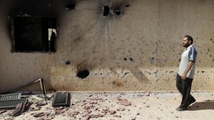 A Libyan man inspects destruction inside