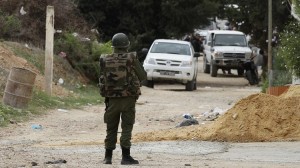A Tunisian soldier patrols a residence in Oued Ellil, west of Tunis