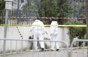 Tunisian forensics police inspect the scene of a suicide bomb attack in Tunis
